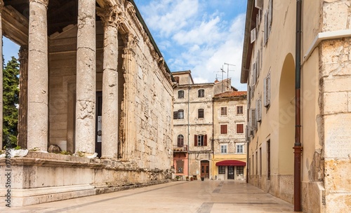 Croatia. Old houses in background of the ancient Roaman temple of Augustus in old town Pula city.