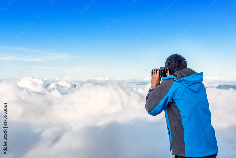 Nature photographer taking photo above the cloud and mountain. Mount Rinjani, Lombok, Indonesia. Nature photographer taking photo above the cloud and mountain. Mount Rinjani, Lombok, Indonesia.
