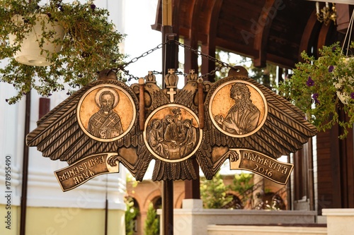 semantron hanging at Plumbuita monastery in Bucharest, Romania. Religious carved metal bronze plate. photo