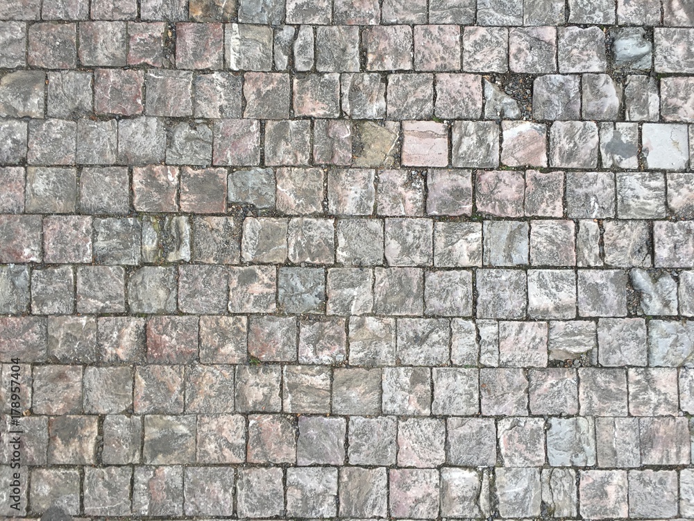 Detail of a textured square bricked pathway Detail of a textured square bricked pathway