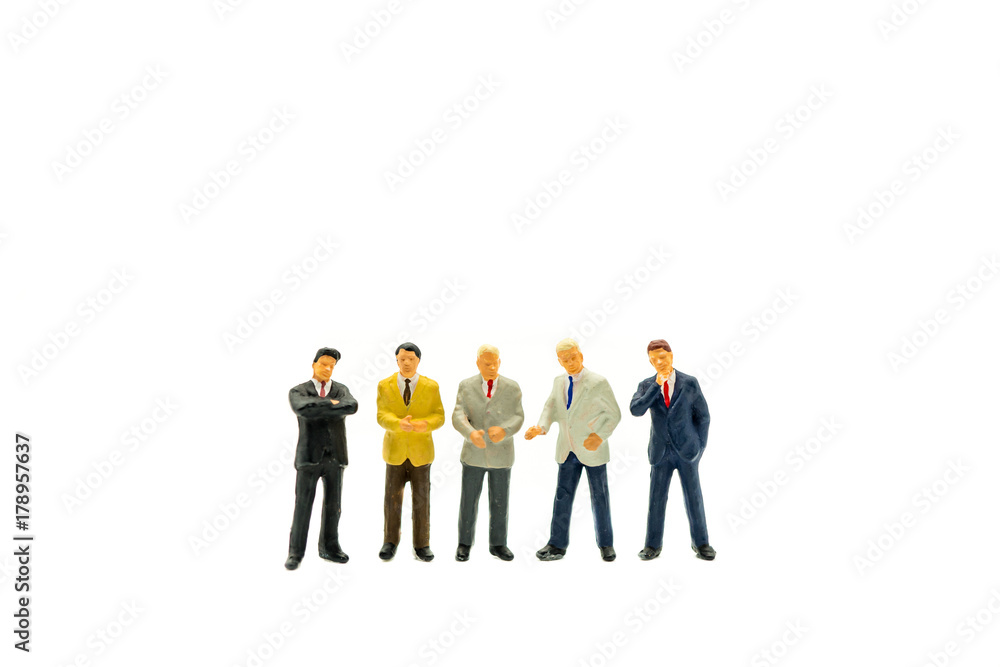 Miniature people, group of businessman standing isolated on white background using as business concept Miniature people, group of businessman standing isolated on white background using as business concept