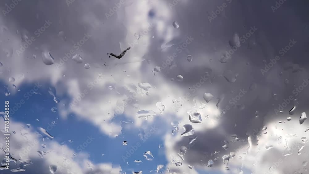 Stormy rain clouds in blue sky, time lapse / Splashes of rain on the glass, time lapse Stormy rain clouds in blue sky, time lapse / Splashes of rain on the glass, time lapse
