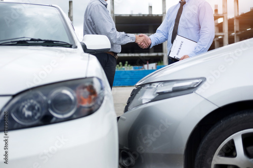 Customer shake hand with auto insurance agents after agreeing to terms of insurance