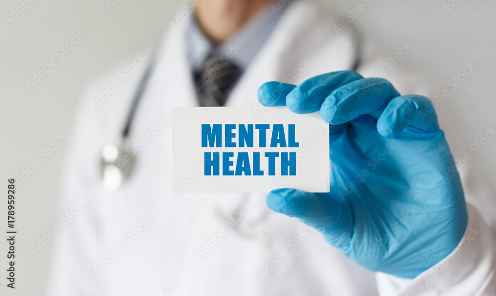 Doctor holding a card with text Mental Health, medical concept