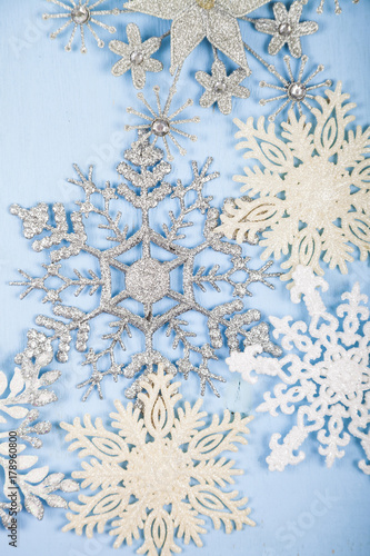 Silvery snowflakes on a wooden background. photo