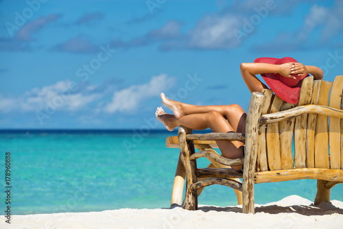 Young beautiful woman enjoying summer vacation, beach relax, summer in tropics