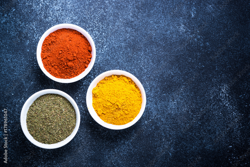 Various spices in a bowls on stone table. Various spices in a bowls on stone table.
