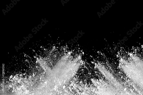 Launched white powder splash on black background.