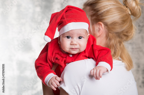 Mother holding Santa claus baby girl. copy space