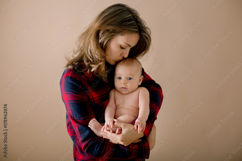 Young mother, caressing her newborn baby boy