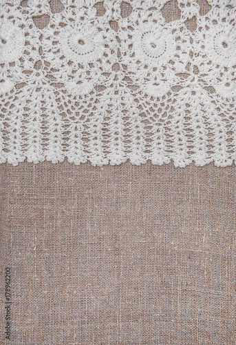 Vintage lace fabric border on the old burlap textile
