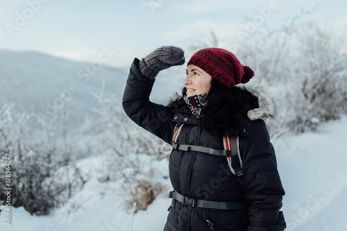 Happy female tourist enjoying snowy country