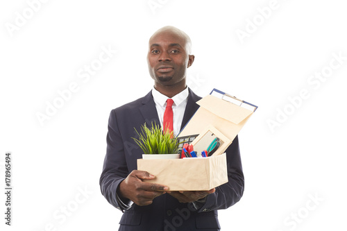 Portrait of African office worker holding box with personal belongings