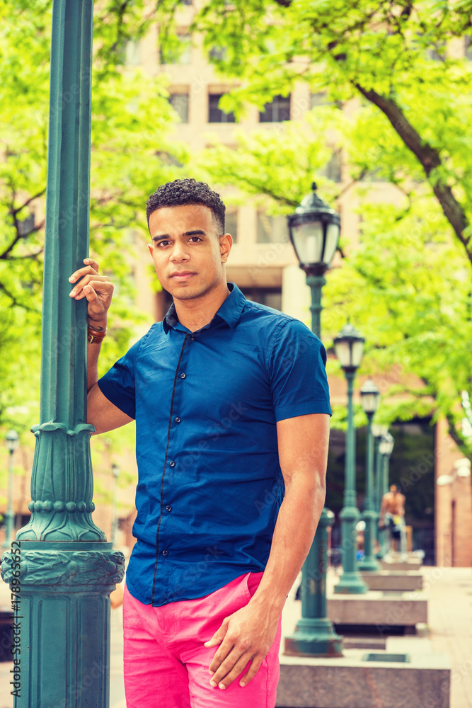 Young African American Man. Wearing blue short sleeve shirt, red