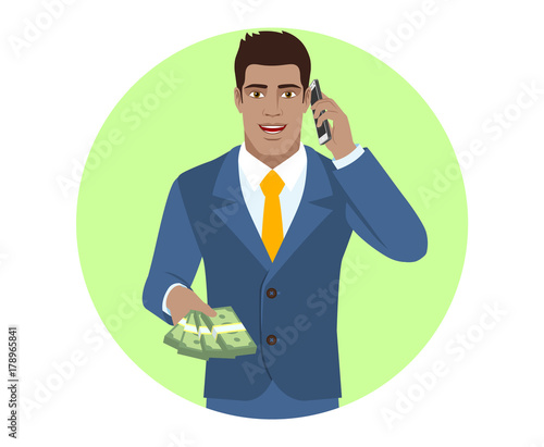 Businessman with cash money talking on the mobile phone