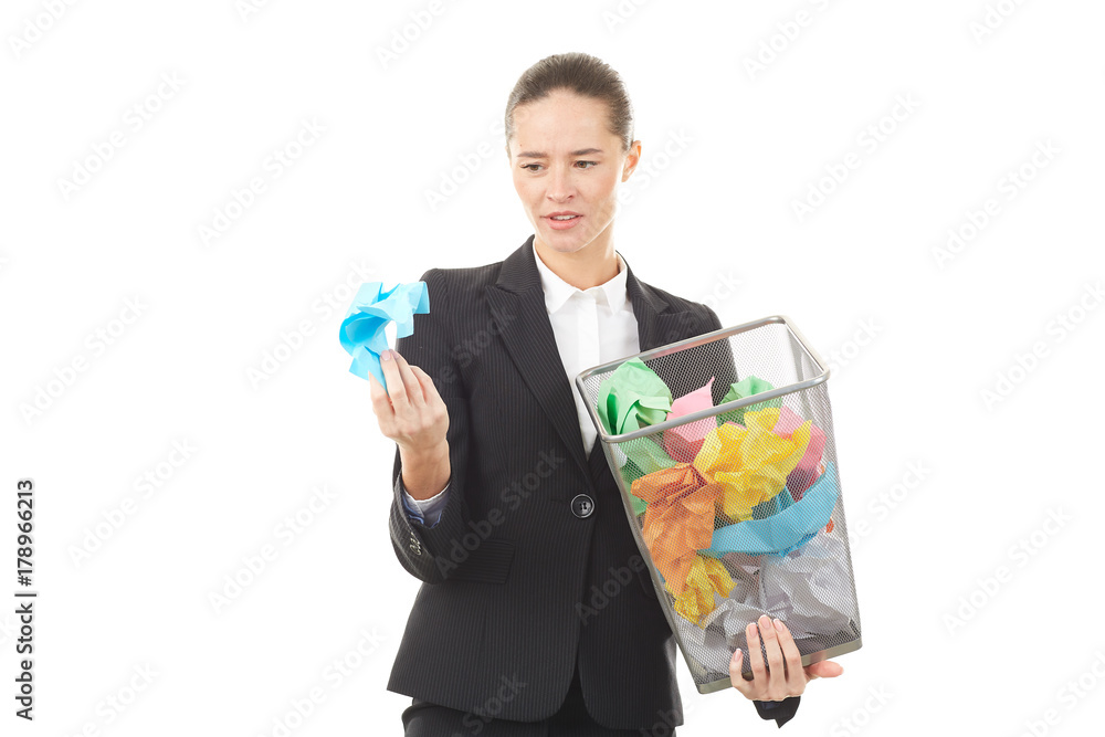 Portrait of female office worker holding basket with crumpled papers Portrait of female office worker holding basket with crumpled papers