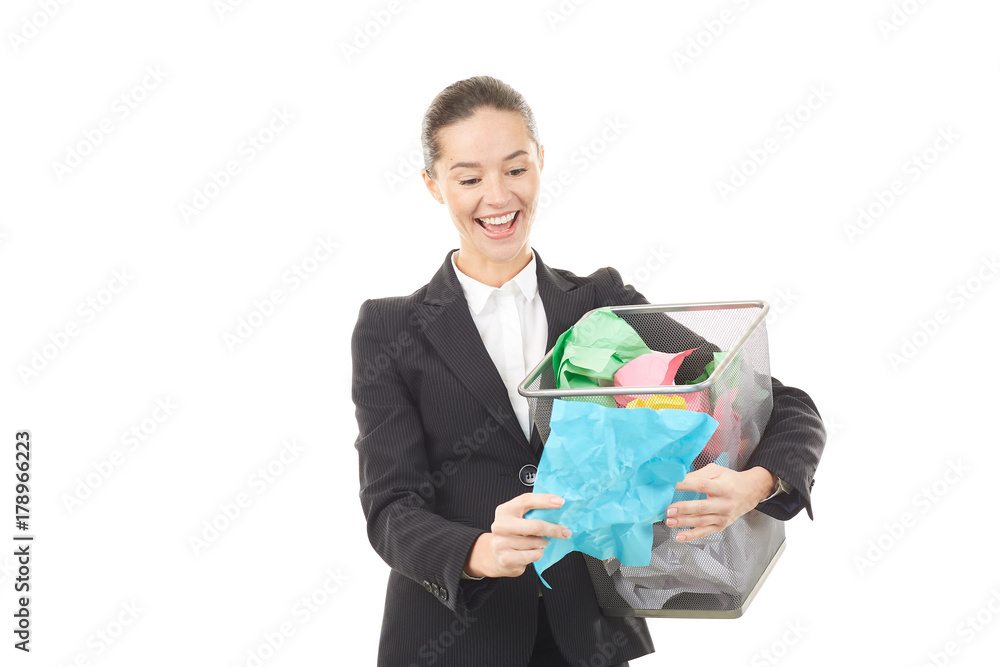 Portrait of female office worker holding basket with crumpled papers