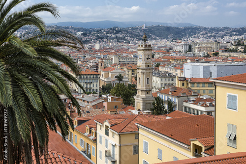 France, Mediterranean Sea, Nice: Skyline with rooftops, tower (Saint-Francois) and mountains in the background. The city is nicknamed Nice la Belle (Nice the Beautiful).