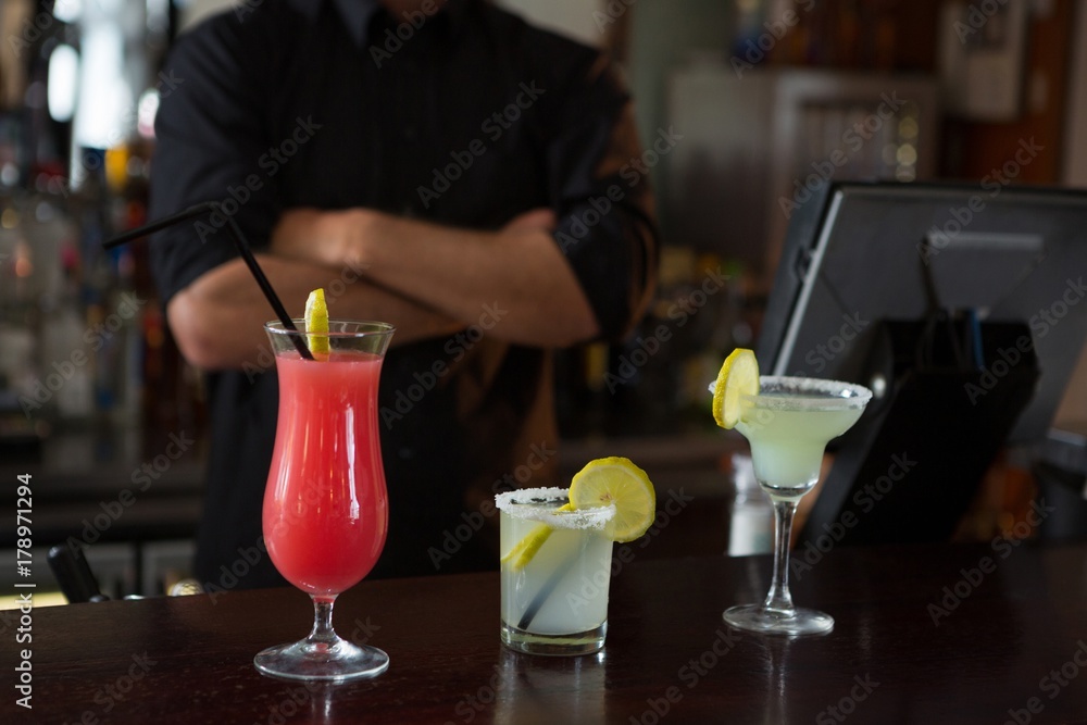 Waiter standing at bar counter Waiter standing at bar counter