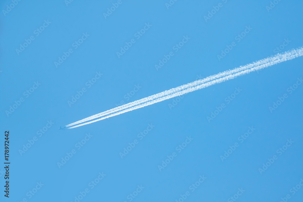 trail of white smoke from the airplane on blue sky trail of white smoke from the airplane on blue sky