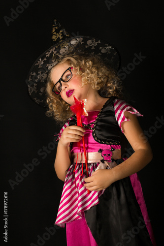 Attractive girl in witch halloween costume