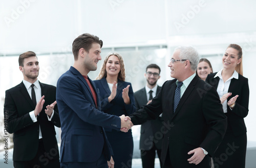 handshake of business partners after a business meeting in the office