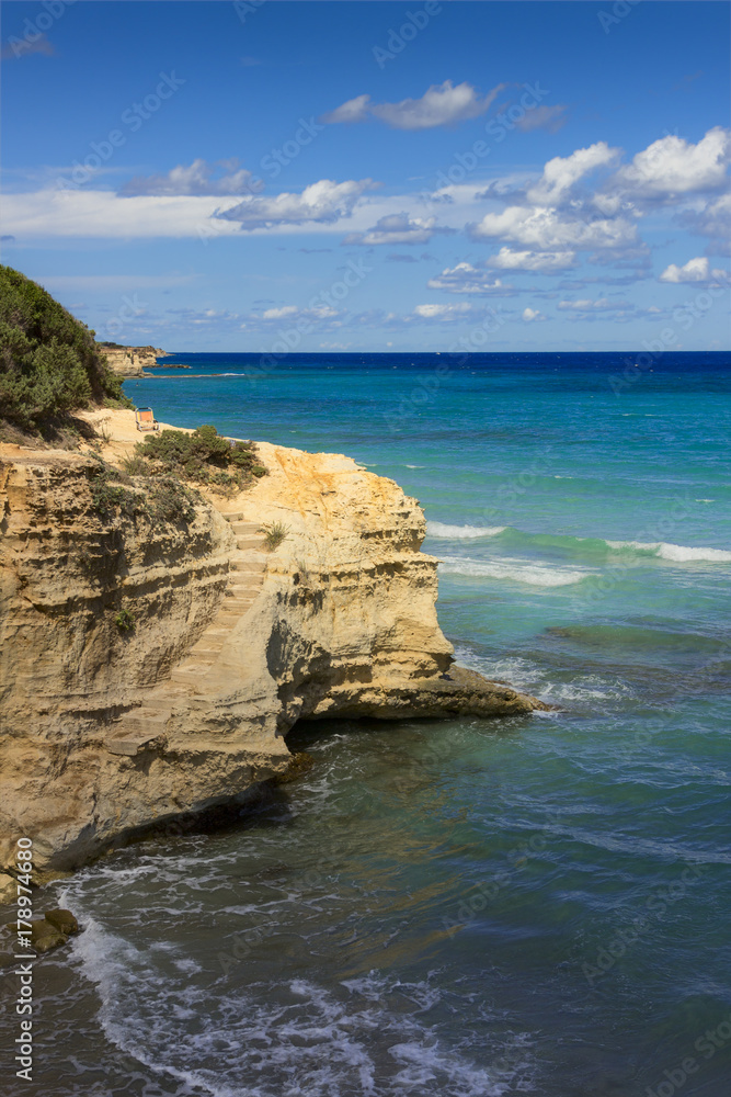 Summertime: a place in the sun.The most beautiful coast of Apulia: Torre Sant' Andrea, Otranto ,ITALY (Lecce).Typical coastline of Salento: seascape with cliffs, rocky arch and sea stacks .