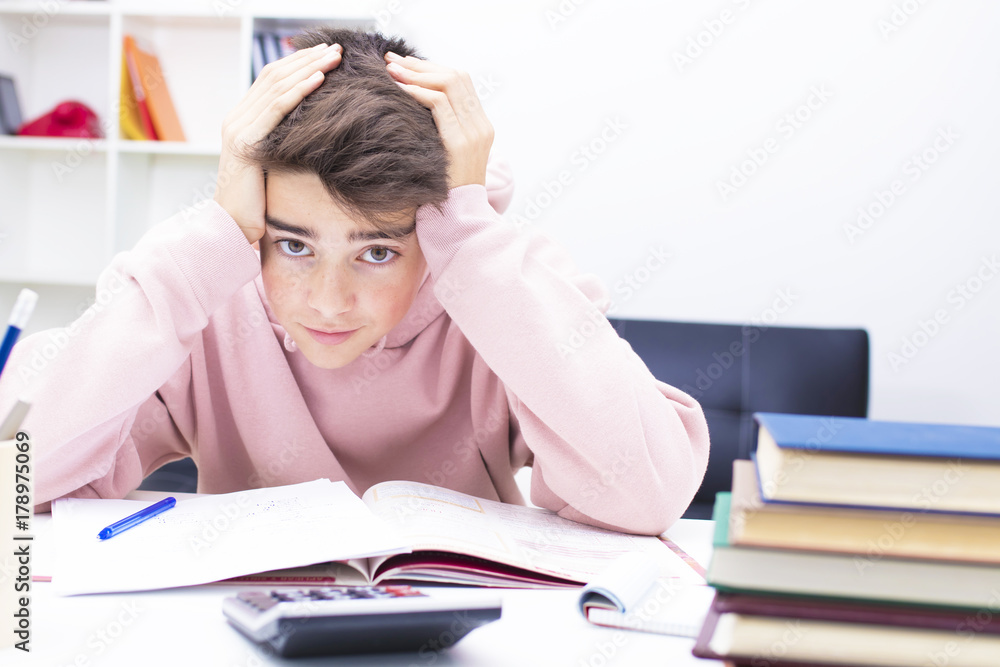 young teenager on the desk studying young teenager on the desk studying