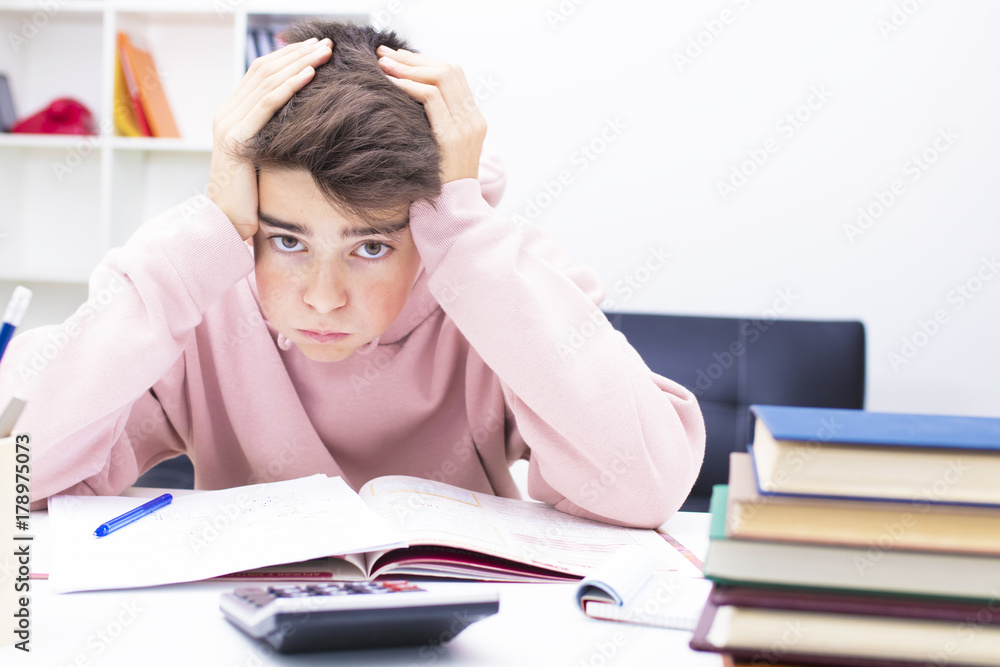 child studying with expression of fatigue and stress child studying with expression of fatigue and stress