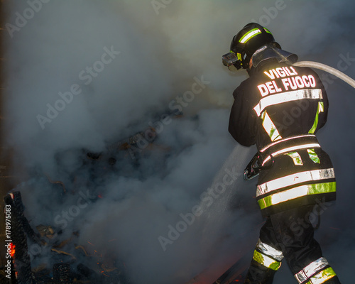 Fireman at work in to the fire