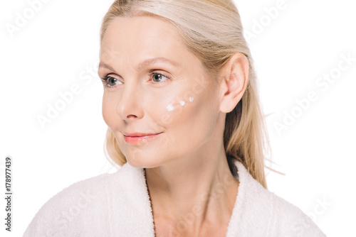 mature woman with cosmetic cream on face