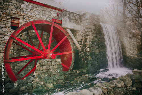working water mill with a red wheel. old grist mill
