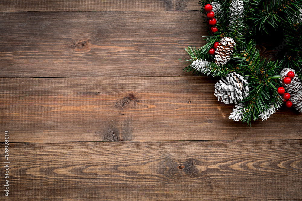 Christmas wreath woven of spruce branches with red berries on wooden background top view copyspace Christmas wreath woven of spruce branches with red berries on wooden background top view copyspace