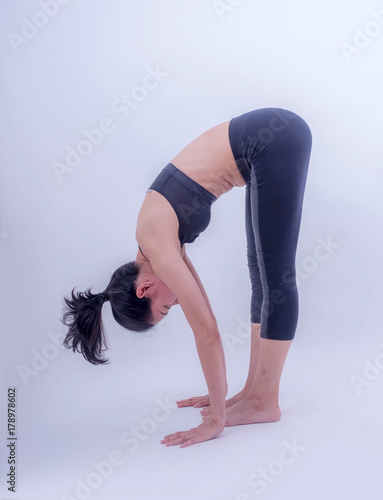 Beautiful young Asian doing yoga exercise isolated on white background. Healthy lifestyle and good wellness concepts