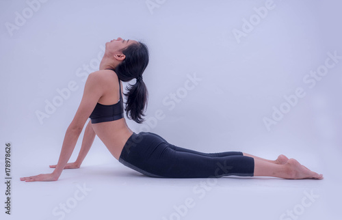 Fototapeta Naklejka Na Ścianę i Meble -  Young beautiful asian fitness girl doing yoga exercise isolated on white background