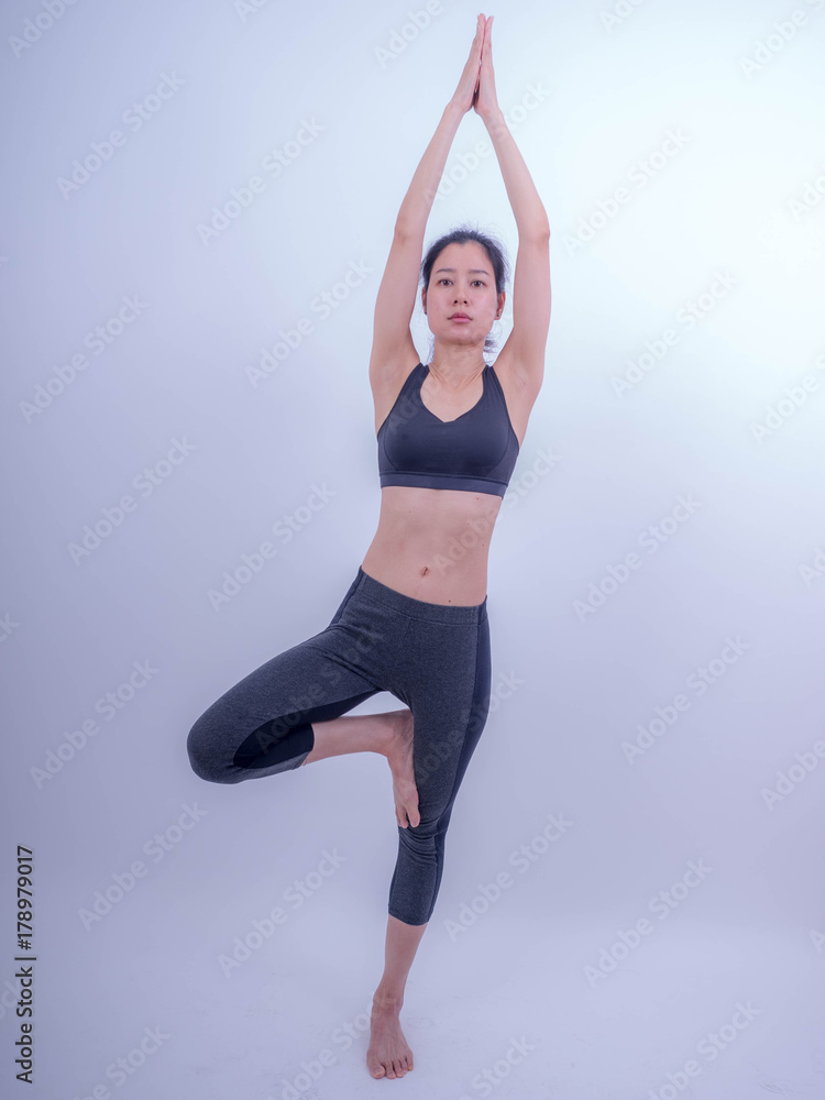 Beautiful young Asian doing yoga exercise. Healthy young girl practicing yoga. Healthy lifestyle and good wellness concepts Beautiful young Asian doing yoga exercise. Healthy young girl practicing yoga. Healthy lifestyle and good wellness concepts