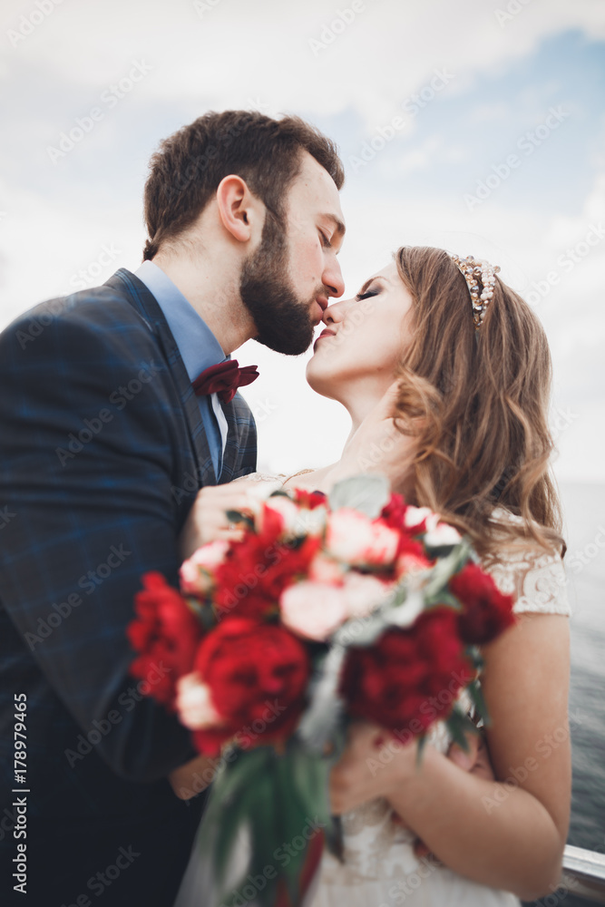 Married wedding couple standing on a wharf over the sea Married wedding couple standing on a wharf over the sea