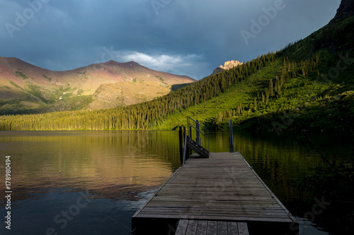 Sunset behind the pier on Lower Two Medicine lake at Glacier national park, Montana, United States photo