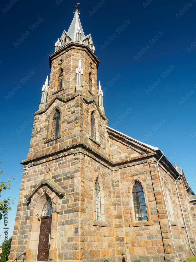 Grand Gothic Revival Catholic Church Against Blue Sky
