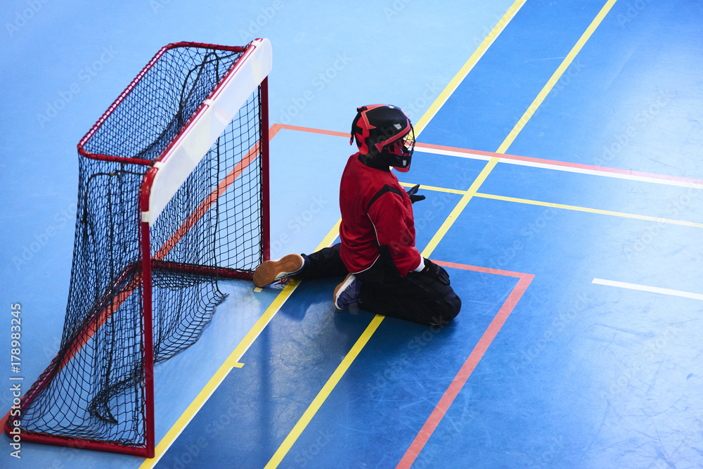 Unidentifiable floorball goalkeeper during mach. Child boy player