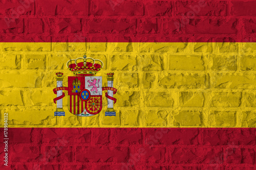 Spain Flag on brick wall texture background