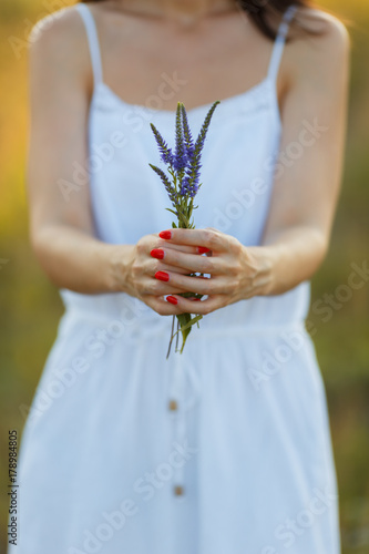 wild flowers in hands of girl