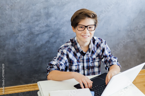 Teenage boy working on lapt...