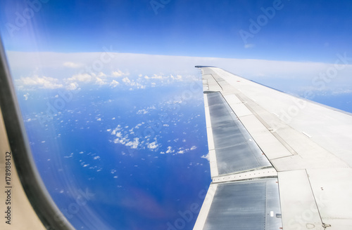 View from the airplane of deep blue sky and clouds. Earth atmosphere. 