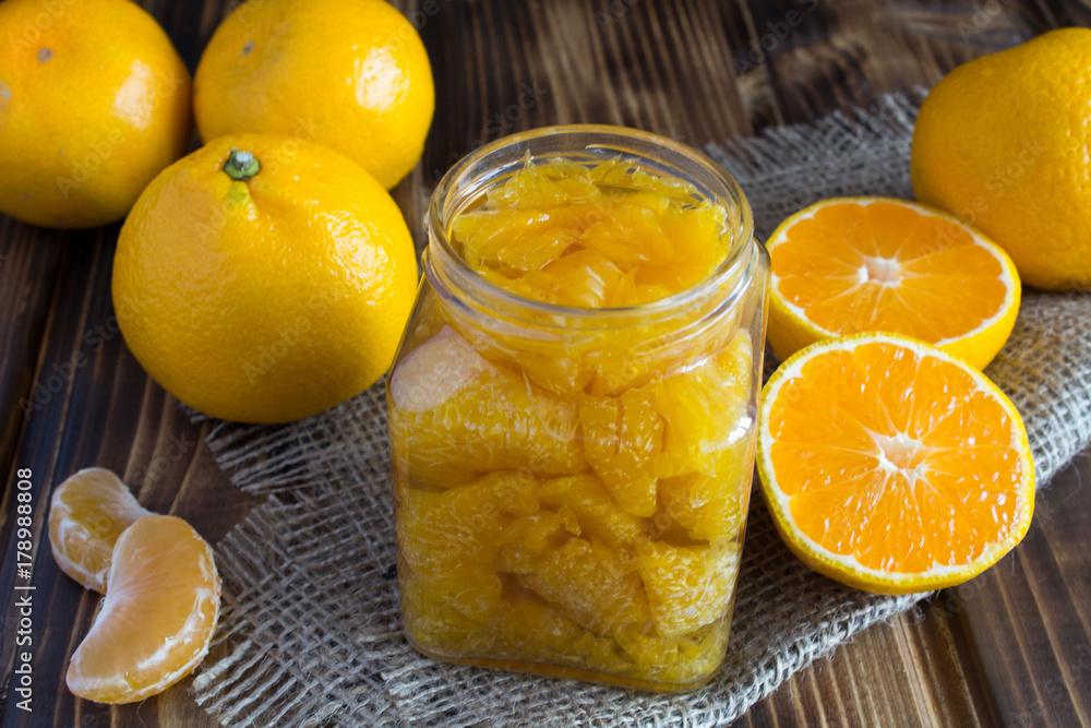 Mandarin jam on the rustic wooden background Mandarin jam on the rustic wooden background