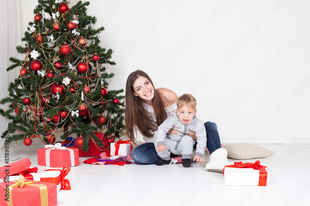 mother and son open gifts on Christmas and new year