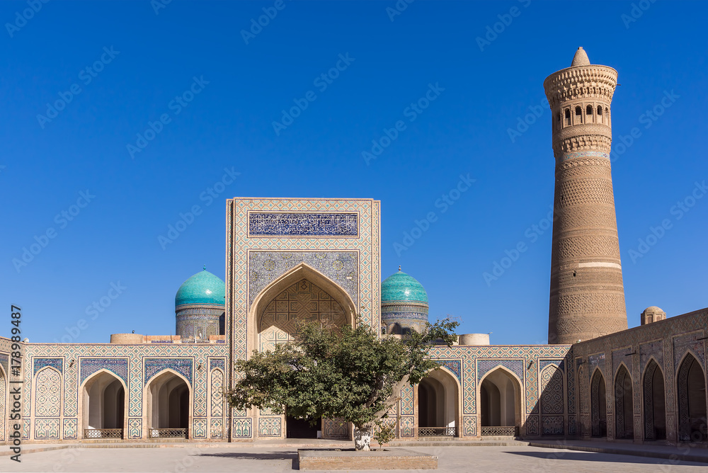 Courtyard at Po-i-Kalyan, with the madrasa and minaret - Bukhara, Uzbekistan. The complex include Kalyan four-iwan mosque and Kalyan minaret.