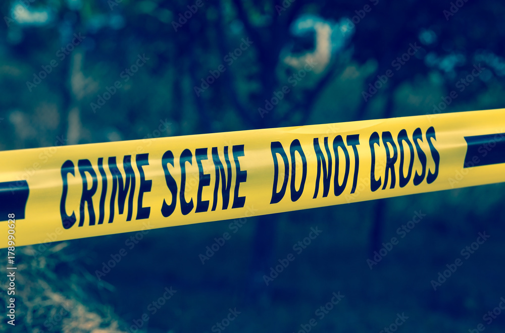 Crime scene tape closeup, police tape Do Not Cross outdoors Stock Photo