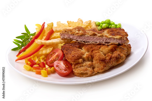Wiener schnitzel with potatoes fries, isolated on white background