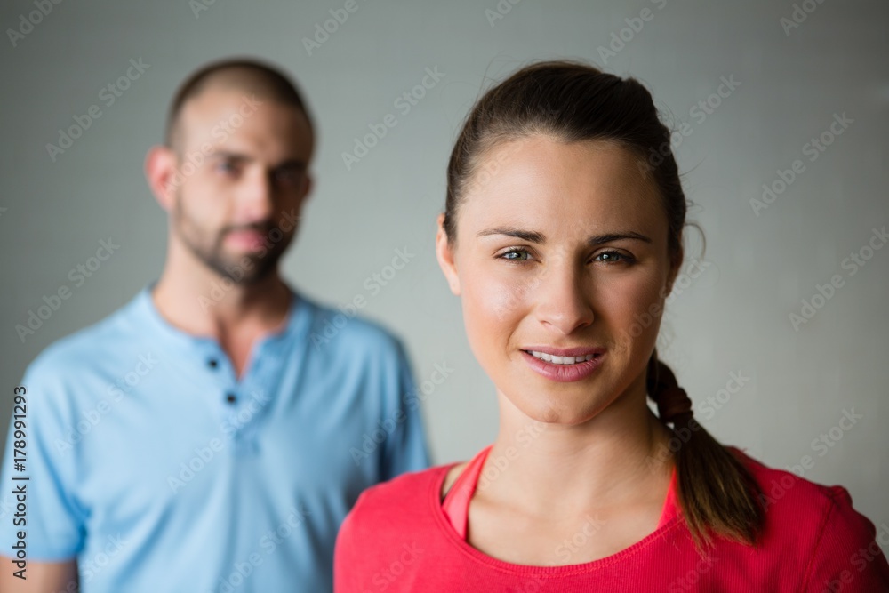 Portrait of student with instructor standing in yoga studio Portrait of student with instructor standing in yoga studio